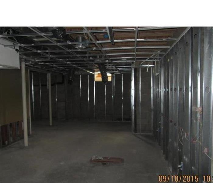 the storage area is dry, the steel studs and ceiling strips are visible, no wallboards