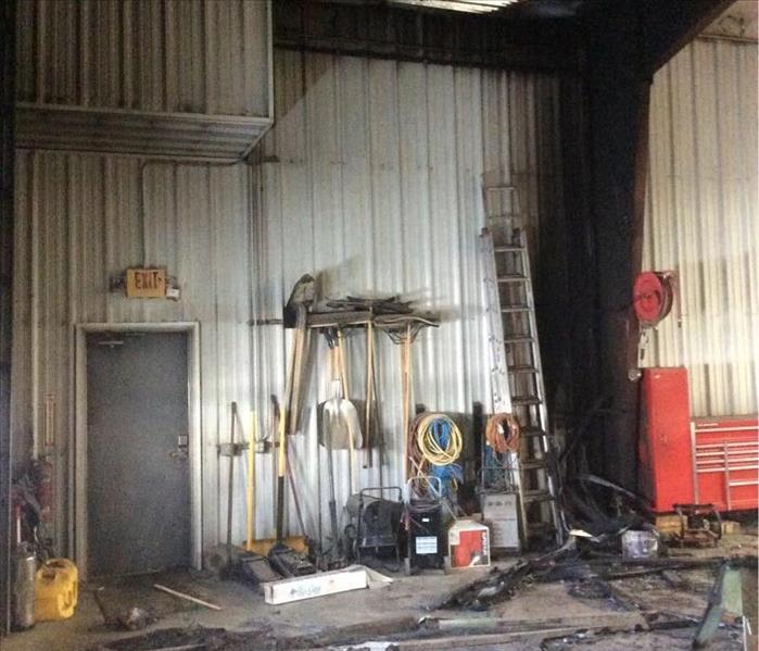 Warehouse with smoke damage on walls and ceiling with tools