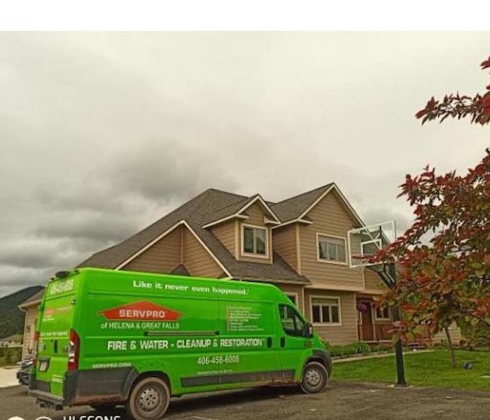 SERVPRO van parked at house with mountains around