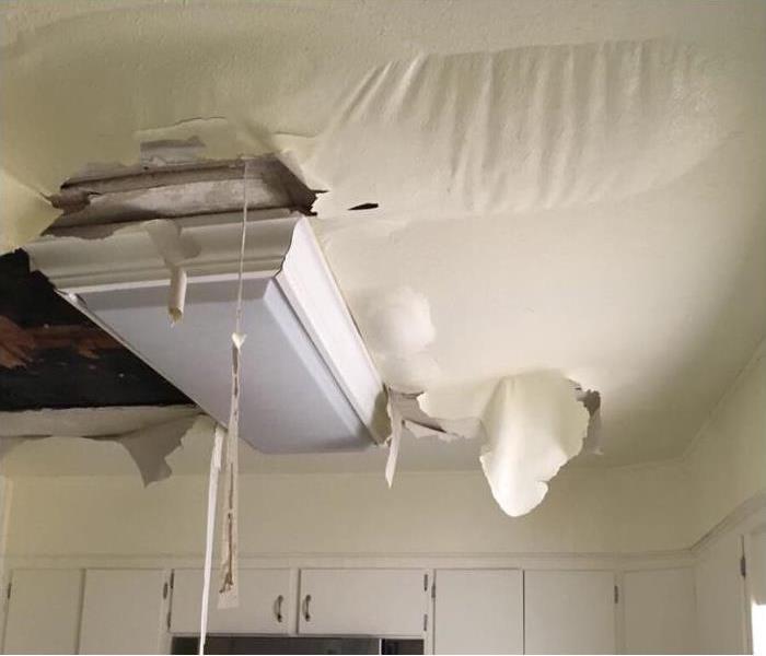 ceiling paint bubbling in a kitchen with water damage